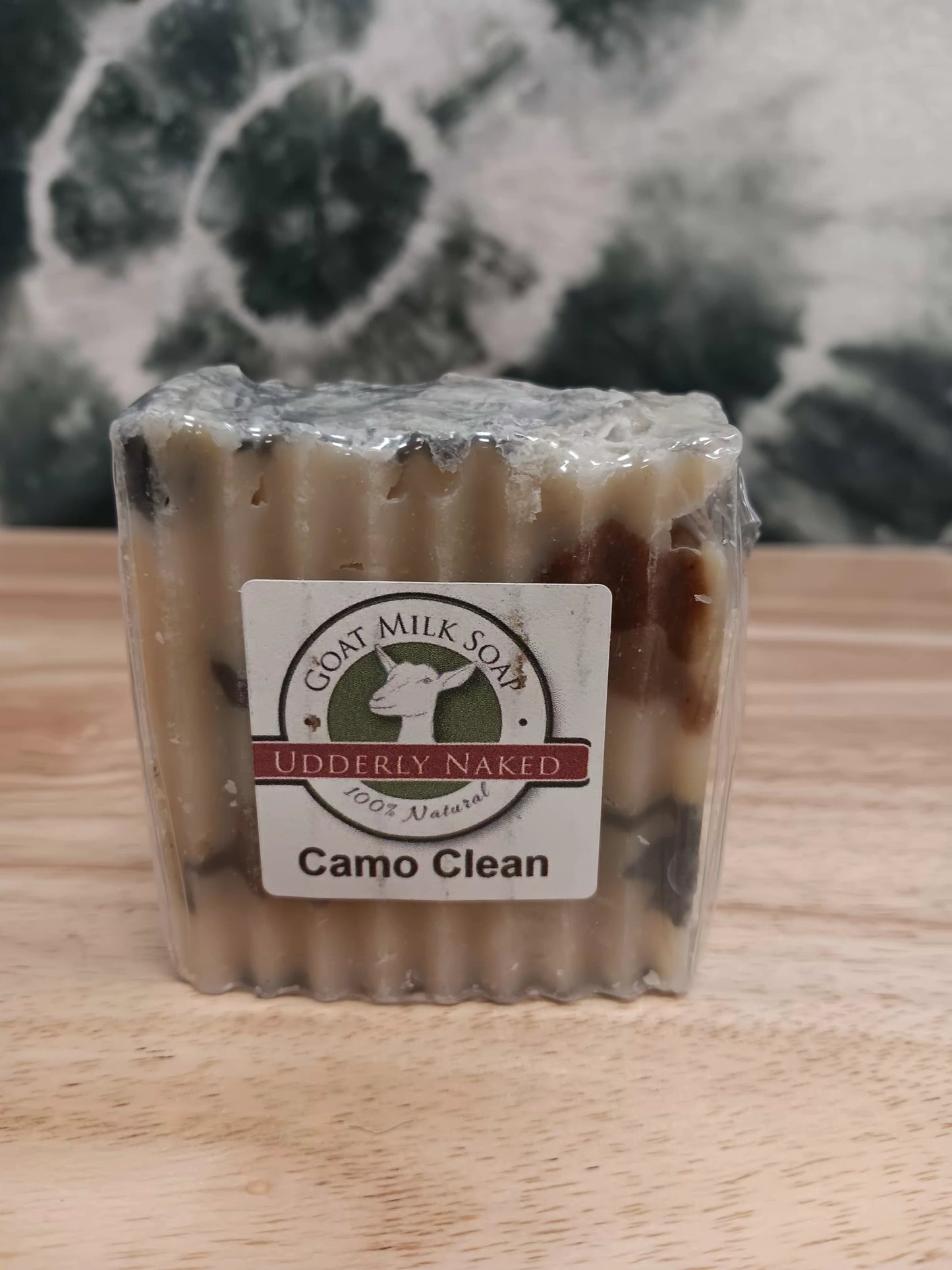 Bar of soap with a label on a wooden surface