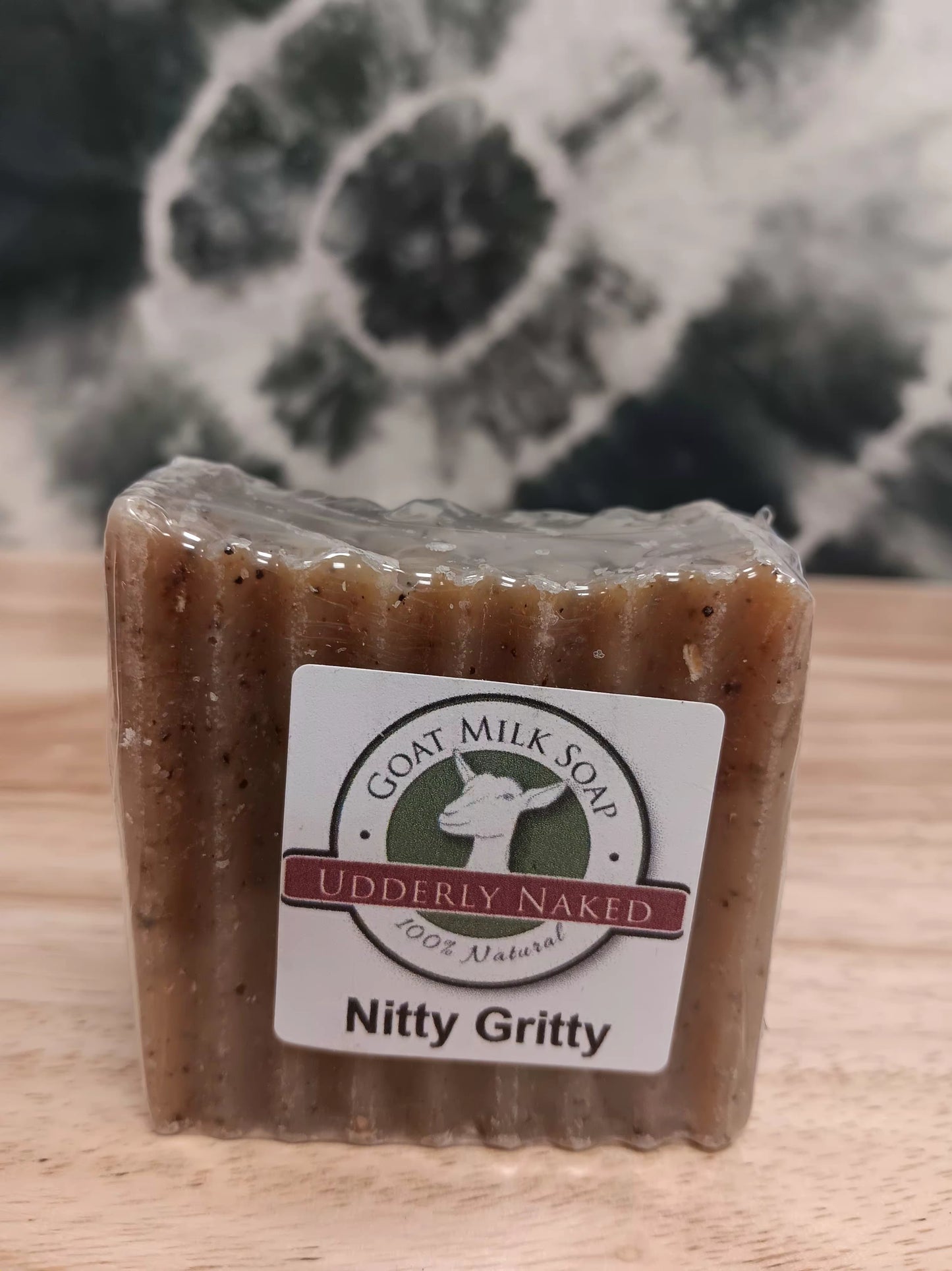 Bar of soap with a label on a wooden surface
