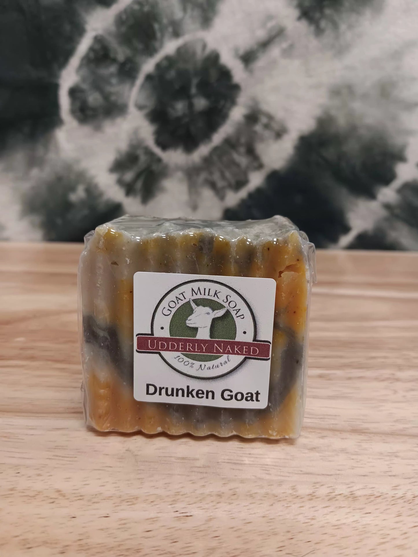 Bar of soap with a label on a wooden surface and marble background
