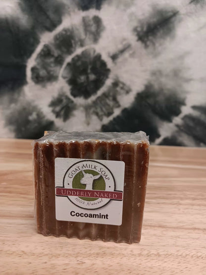 Bar of soap with a label on a wooden surface and floral background