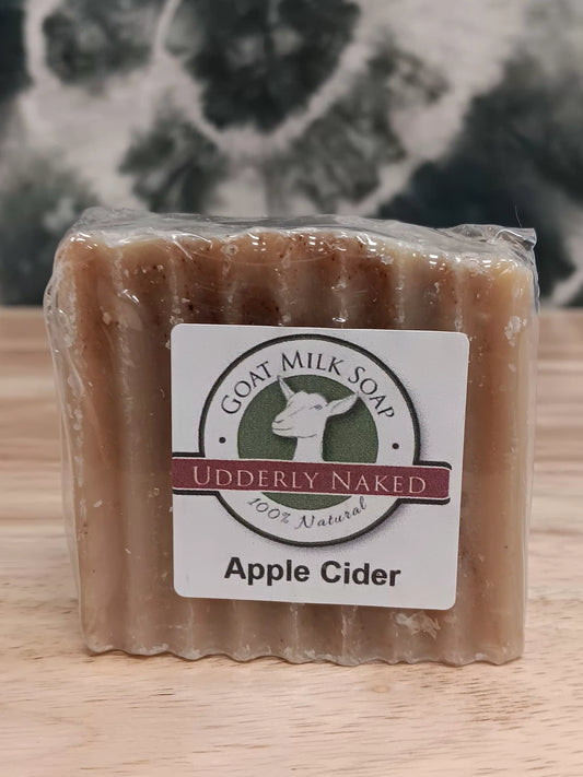 Bar of soap with a 'Goat Milk Soap' label on a wooden surface